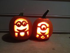 two pumpkins carved to look like minion faces with the words steelers on them