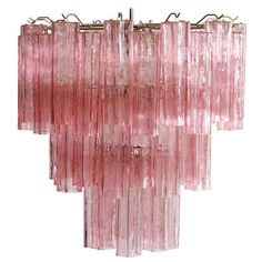 a pink glass chandelier hanging from a metal rod with five lights on each end