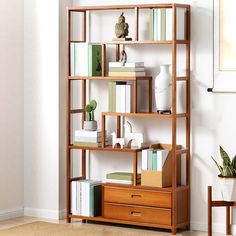 a bookshelf filled with lots of books next to a wall