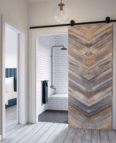 an open door leading to a bathroom with white brick walls and wood flooring on the outside