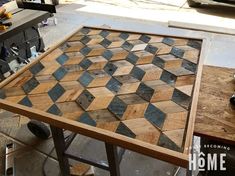 a wooden table topped with lots of different types of wood tiles on top of it