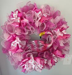 a pink wreath with a flamingo on it