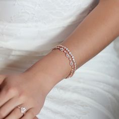 For an elegant and classic look, this classic tennis bracelet paired with a Round and Tear Drop CZ bracelet is the perfect combo bracelet set. Each stone has a bezel setting, so it will not snag on fabrics. This bracelet has the perfect combination, dainty but still has enough crystal to keep it shining. SOLD SEPARATELY. MATERIALS & MEASUREMENTS - 18K White Gold, Gold, Rose Gold over Brass - Cubic Zirconia pave crystals - Fold-over Clasp - Width 0.25 in (6 mm) - Hypoallergenic, Lead & Ni Delicate Gold Beaded Bracelets For Wedding, Dainty Round Bangle For Wedding, Rose Gold Tennis Bracelet For Wedding, Delicate Gold Bracelets For Wedding, Delicate Bangle Bracelets For Wedding, Gold Beaded Bracelets For Wedding, Dainty Bangle Bracelet For Wedding, Delicate Wedding Bangle Bracelet, Wedding Tennis Bracelet With Round Stones