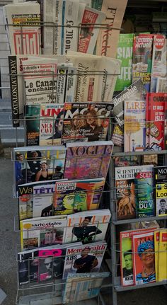 there are many magazines stacked on the cart