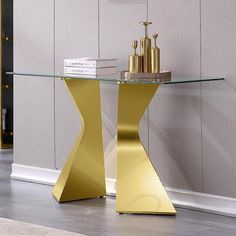 a glass table with gold colored furniture in the corner and white carpet on the floor