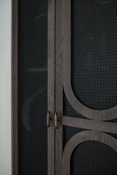 a close up of a wooden cabinet with perfored design on the front and sides