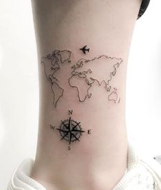 a woman's neck with a world map tattoo on her left side ribcage