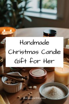 a table topped with candles and bowls filled with marshmallows next to a sign that says handmade christmas candle gift for her