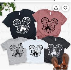 three shirts with mickey mouse ears on them and one is pink, the other is grey