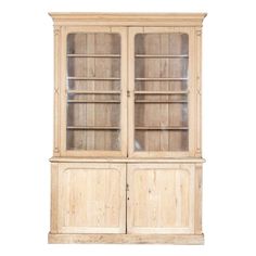 an old wooden china cabinet with glass doors and shelves on one side, against a white background