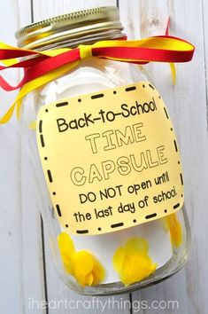 back to school time capsule jar with yellow flowers in it and a red ribbon on top