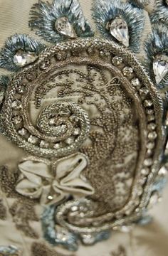 close up view of the back of a dress with beading and sequins