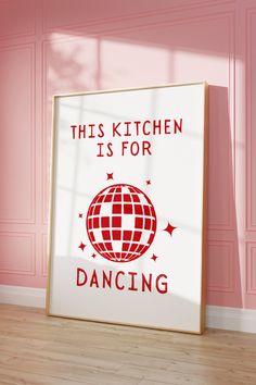 this kitchen is for dancing sign in front of a pink wall and wooden flooring