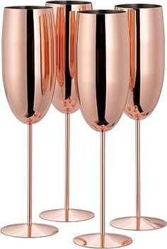 four rose gold wine glasses with black rims