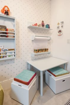 a white table and two storage boxes in a room