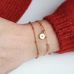 "Dainty Bracelet set in Gold. Personalize the Disk with an Initial or Leave it blank. The chains are dainty and glistening, making it the perfect bracelet set for a special occasion as well as everyday wear. SOLD AS A SET. Our modern paperclip & satellite ball Bracelet is the perfect layering gift set for your bridesmaid, Unbiological sister, sister in law, bonus sister, mother in law, mother of the groom, or gift from bride to maid of honor. Super dainty and feminine. ---------------------- Bridesmaid Letter, Paper Clip Bracelet, Lingot D'or, Gold Bar Necklace Personalized, Unbiological Sister, Delicate Gold Necklace, Layered Bracelet, Custom Initial Necklace, Bracelet Initial