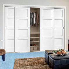 a living room filled with furniture and white closet doors