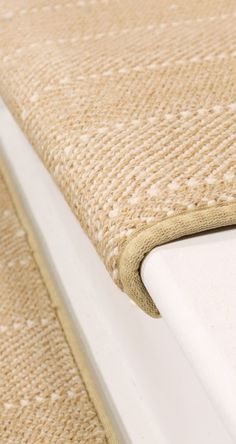 a close up view of the edge of a bed