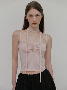 This product features a sleeveless top with an intricate shirring design that brings a textural element to the garment. The unique scarf-like straps create an eye-catching neckline, adding a modern twist to a classic black top. Its cropped cut makes it versatile for pairing with high-waisted bottoms for both casual and dressier occasions. - The top's shirring detail not only adds visual interest but also ensures a flattering fit.- Scarf-inspired straps tie elegantly around the neck, offering a customizable fit and a hint of sophistication.- Made with a stretchable fabric, this top provides comfort and conforms beautifully to the body's shape.- Its cropped length makes it a perfect piece to combine with various separates, enhancing its day-to-night versatility. Elegant Spring Halter Top With Straps, Elegant Halter Top With Straps For Spring, Elegant Spring Halter Top, Elegant Tops With Knotted Straps, Elegant Spring Tops With Knotted Straps, Stretch Tops With Multiple Straps, Chic Tops With Knotted Straps For Party, Chic Ruched Sleeveless Blouse Tank Top, Elegant Ruched Cami Top