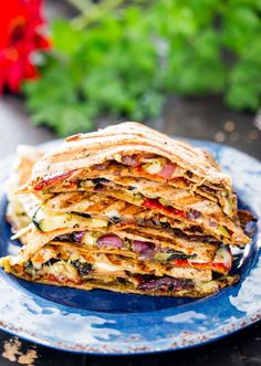 a stack of quesadilla stacked on top of each other in a blue plate