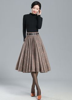 "This winter wool skirt is a classic piece of tailoring that will see you through rain or shine. It is cut with a flattering flared skirt to give you a wonderful shape. The winter skirt is perfect classic styling and ends at the ankle. This is a versatile skirt that you'll wear again and again. DETAILS: * 30% wool, 30% fiber, 40% polyester * fully satiny liner * Two side pockets * Right zip closure * has belt loops to keep everything in place * Plus size full skirt * Perfect for Winter, autumn * Classic Fall Midi Skirt, Wool Midi Pleated Skirt, Wool Pleated Long Skirt, Classic Knee-length Skirt For Fall, Retro Winter Skirt, Winter Wool Pleated Skirt, Fitted Winter Pleated Lined Skirt, Vintage Knee-length Winter Bottoms, Classic Flared Pleated Skirt For Winter