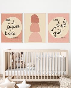 a baby crib with two posters on the wall