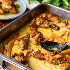 a pan filled with meat and sauce on top of a table