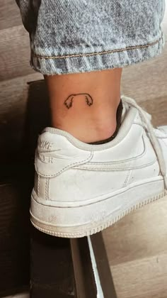 a person with a small tattoo on their ankle