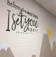 there is a mural painted on the wall in this school's hallway that says, before you were born i set you apart