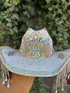 Rhinestone cowboy hats -Gold detailing -Iridescent gemstones -Silver tassels on each side of the hat -Hand rhinestoned  No two pieces are exactly the same and will have slight variations, depending on material availability.  Please note this item is pre-order only and will take 4-6 week to be created. Available in black or white base Blinged Out Cowboy Hat, Diy Embellished Cowboy Hat, Bedazzled Cowboy Hats, Cowboy Hat Customized, Decorated Hats Diy, Bling Cowgirl Hat, Rhinestone Cowgirl Hat, Rhinestone Cowboy Hat, Cowboy Hat Design