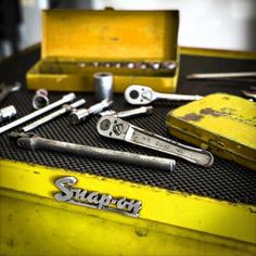 there are many wrenches and other tools in the box on the table with it's contents