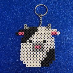 a keychain made out of legos with a dog on it's face