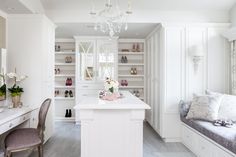 All-white Walk-in Closet with Crystal Chandelier This all-white master closet is bathed in natural light! Traditional Closet, Recessed Panel Cabinets