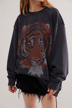 a woman wearing a sweatshirt with a tiger on it