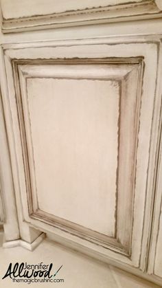 an old white cabinet painted with chalk paint and chippings on the door frame