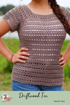 a woman standing with her hands on her hips wearing a crochet top and jeans