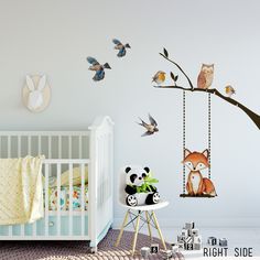 a baby's room with an animal themed wall decal