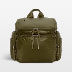 an olive green backpack with zippers on the front