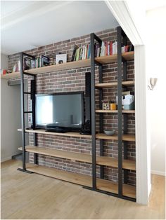 an entertainment center with bookshelves and a television