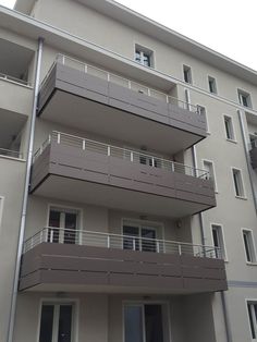 an apartment building with balconies on the second floor