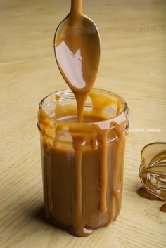 caramel sauce being poured into a glass jar