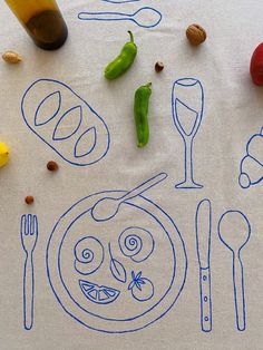 a table topped with different types of food and utensils on top of a white cloth