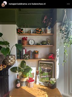 a wooden table topped with potted plants next to a shelf filled with books and other items