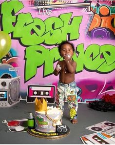 a young child standing in front of a cake with the word fresh prince on it