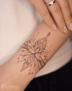 a woman's arm with a flower tattoo on the left side of her arm