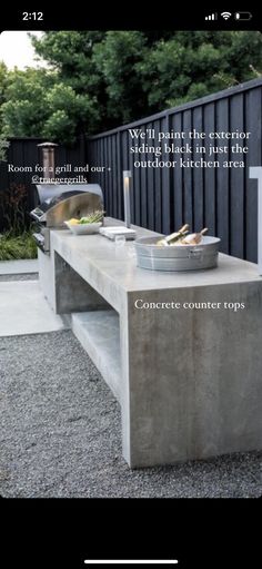 an outdoor kitchen with concrete counter tops and built - in grills, is shown here