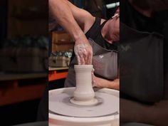 a man is making a vase out of clay and then spinning it on the potter's wheel