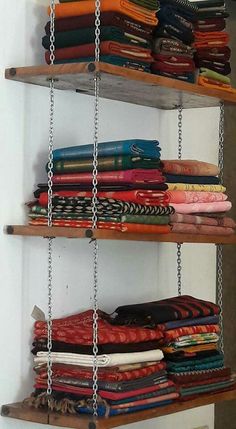 the shelves are filled with different types of fabrics