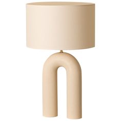 a white lamp with a beige shade on it's base and an oval shape