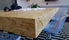 a wooden table sitting on top of a checkered floor